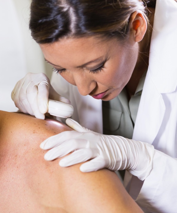 Dermatologist examining shoulder